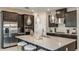 Modern kitchen with stainless steel appliances, dark cabinets, and a large center island at 4711 Coral Harbour Rd, Kissimmee, FL 34758