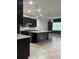 Modern kitchen with a large island, granite countertops, stainless steel appliances, and globe lighting at 4783 Riverwalk Dr, St Cloud, FL 34771