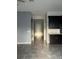 Open-concept living area with tile floors, dark cabinets and easy access to the front door at 4783 Riverwalk Dr, St Cloud, FL 34771