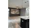 Open living space with tile floors, dark cabinets, decorative lighting and an accent wall at 4783 Riverwalk Dr, St Cloud, FL 34771