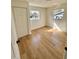 Bedroom features wood-look flooring, two windows, and closet at 701 N 4Th St, Haines City, FL 33844