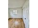 This light bedroom features wood-look floors, white walls, closet, and a window at 701 N 4Th St, Haines City, FL 33844