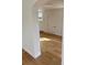 Hallway leading to the staircase with attractive flooring and white trim at 701 N 4Th St, Haines City, FL 33844