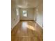 Spacious living room features attractive flooring, neutral paint, and archway to other rooms at 701 N 4Th St, Haines City, FL 33844