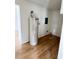 Bright utility room with A.O. Smith water heater and wood-look flooring at 701 N 4Th St, Haines City, FL 33844