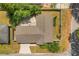Aerial view of the home's roof, back yard, deck, fence, and proximity to neighborhood street at 704 Briarwood Dr, Winter Springs, FL 32708