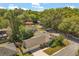 Aerial view of a well-maintained home with fenced yard, mature landscaping, and neighborhood street at 704 Briarwood Dr, Winter Springs, FL 32708