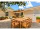 Backyard patio offers outdoor dining with a wooden table, chairs, plants, and landscaping at 704 Briarwood Dr, Winter Springs, FL 32708