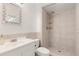 Neutral bathroom featuring walk-in shower, single sink vanity, decorative mirror, and tiled walls at 704 Briarwood Dr, Winter Springs, FL 32708