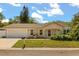 Charming single-story home featuring a well-manicured lawn and an attached two-car garage at 704 Briarwood Dr, Winter Springs, FL 32708