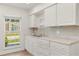 Kitchen featuring white cabinets, a sink, and a window bringing in natural light at 704 Briarwood Dr, Winter Springs, FL 32708