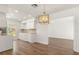 Well-lit kitchen with a view to the living room and featuring white cabinets and modern appliances at 704 Briarwood Dr, Winter Springs, FL 32708