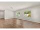 Bright living room with wood-look flooring and natural light from the multiple windows at 704 Briarwood Dr, Winter Springs, FL 32708