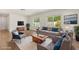 Cozy, virtually staged living room with modern furnishings and wood-look flooring at 704 Briarwood Dr, Winter Springs, FL 32708