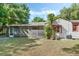 Spacious backyard with lush greenery, a screened-in patio, and charming exterior details at 718 31St St, Orlando, FL 32805