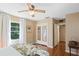 Bedroom featuring window, closet with mirrored doors, and a view to another room at 718 31St St, Orlando, FL 32805