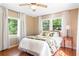 Comfortable bedroom with hardwood floors, fan, windows with sheer curtains, and floral bedding at 718 31St St, Orlando, FL 32805