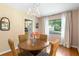 Charming dining area with a chandelier, hardwood floors, and a view of the neighborhood at 718 31St St, Orlando, FL 32805
