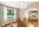Bright dining room with large window, chandelier, and hardwood floors at 718 31St St, Orlando, FL 32805