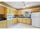 Well-lit kitchen with ample cabinet space, a vintage stove, and checkered flooring at 718 31St St, Orlando, FL 32805