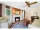 Inviting living room with a brick fireplace, ceiling fan, and hardwood floors at 718 31St St, Orlando, FL 32805