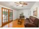 Living room featuring hardwood floors, a leather sofa, and a view to a deck through the French doors at 718 31St St, Orlando, FL 32805