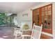 Cozy patio with rocking chairs and natural light, leading to the house through elegant glass doors at 718 31St St, Orlando, FL 32805