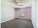 A bedroom with soft carpet features a window with a curtain and a ceiling fan at 753 Sandy Bar Dr, Winter Garden, FL 34787