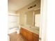 Bright bathroom featuring a shower over tub, tile flooring, and a vanity with a large mirror at 8276 Maritime Flag St # 201, Windermere, FL 34786