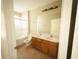 Bathroom featuring a double vanity, tiled floors, and a glass-enclosed shower, designed for comfort and functionality at 8276 Maritime Flag St # 201, Windermere, FL 34786