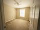 Cozy bedroom with neutral walls, plush carpet, and a bright window, creating a peaceful retreat at 8276 Maritime Flag St # 201, Windermere, FL 34786