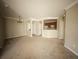 Spacious living room with neutral carpet, crown molding, and an open view into the kitchen and dining nook at 8276 Maritime Flag St # 201, Windermere, FL 34786