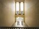 Open stairwell with natural light streaming through glass doors and geometric railings on a multi-level building at 8276 Maritime Flag St # 201, Windermere, FL 34786