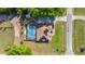 Top-down aerial view showcasing a home with a screened pool and solar panels in a country setting at 8499 Se 155Th, Summerfield, FL 34491