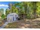 Backyard with a shed, a grilling area, and an outdoor fountain at 8499 Se 155Th, Summerfield, FL 34491