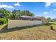 View of the white-fenced backyard with a screened-in pool enclosure, offering privacy and outdoor living at 8499 Se 155Th, Summerfield, FL 34491