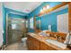 Bathroom featuring double sinks with granite countertops and a glass-enclosed shower at 8499 Se 155Th, Summerfield, FL 34491