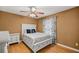 Comfortable bedroom featuring a ceiling fan, a classic white bed and neutral walls and curtains at 8499 Se 155Th, Summerfield, FL 34491
