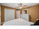 Bright bedroom featuring a ceiling fan, a classic white dresser and closet with neutral colored walls at 8499 Se 155Th, Summerfield, FL 34491