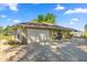 Side view of a house with a two-car garage and a long driveway at 8499 Se 155Th, Summerfield, FL 34491