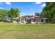 Charming single-story home with lush lawn, solar panels, and well-manicured landscaping at 8499 Se 155Th, Summerfield, FL 34491