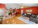 Cozy living room flowing to an open kitchen with breakfast bar seating and hardwood flooring throughout at 8499 Se 155Th, Summerfield, FL 34491