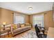 Bright home office featuring a comfortable couch, natural light, and a neutral color palette at 8499 Se 155Th, Summerfield, FL 34491
