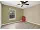 This simple bedroom has a ceiling fan, a window, and vinyl plank flooring at 8703 Grandee Dr, Orlando, FL 32829