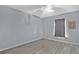 This room has a ceiling fan, a window, and gray-stained plank flooring, offering comfort and style at 8703 Grandee Dr, Orlando, FL 32829
