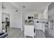 Eat-in kitchen features all-white cabinets and stainless appliances, seamlessly connected to living spaces at 8703 Grandee Dr, Orlando, FL 32829