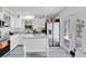 Modern kitchen with white cabinets, stainless steel appliances, granite counters and wood-look floors at 8703 Grandee Dr, Orlando, FL 32829