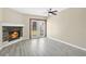 Cozy living room featuring a stone fireplace, neutral paint, modern ceiling fan and walkout to the backyard at 8703 Grandee Dr, Orlando, FL 32829