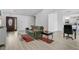 Inviting living area with wood-look flooring, neutral paint, and open flow to the dining and kitchen area at 8703 Grandee Dr, Orlando, FL 32829
