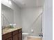 Clean bathroom featuring a vanity with granite countertops, a toilet, and a shower with good lighting at 8908 Azalea Sands Ln, Davenport, FL 33896